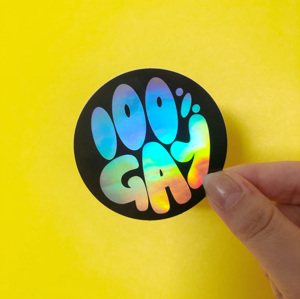 Decorative sticker with text '100% Gay' on a yellow background.